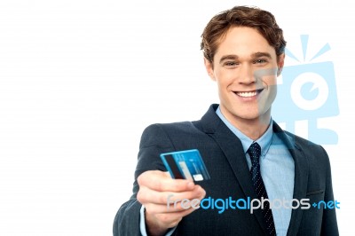 Smiling Businessman Offering His Debit Card To You Stock Photo