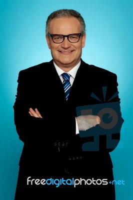 Smiling Businessman Posing With Crossed Arms Stock Photo