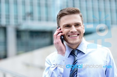 Smiling Businessman Talking On The Phone Stock Photo