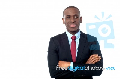Smiling Businessman With Arms Crossed Stock Photo