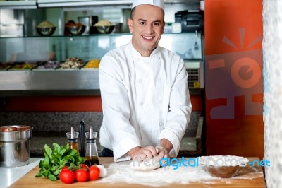 Smiling Chef Preparing Pizza Base Stock Photo