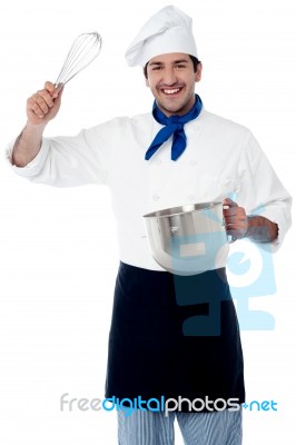 Smiling Chef Showing Kitchen Essentials Stock Photo