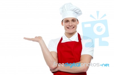 Smiling Chef Showing Open Palm Stock Photo
