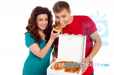 Smiling Couple Eating Pizza Stock Photo