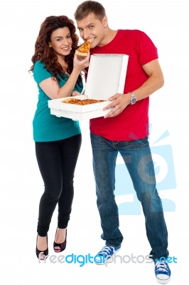 Smiling Couple Eating Pizza Stock Photo