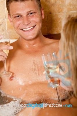 Smiling Couple Holding Champagne Stock Photo