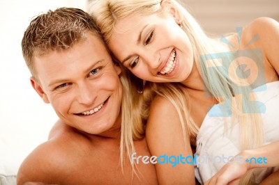 Smiling Couple In Bed Stock Photo