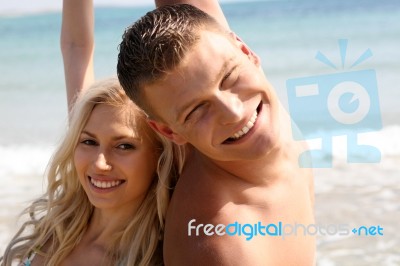 Smiling Couples At Beach Stock Photo