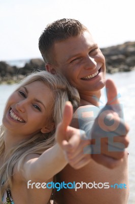Smiling Couples Thumb Up Stock Photo