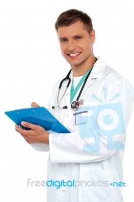 Smiling Doctor holding Clipboard Stock Photo