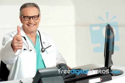 Smiling Doctor Showing Thumbs Up Stock Photo