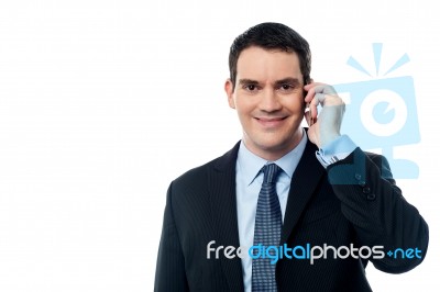 Smiling Executive Talking Via Mobile Phone Stock Photo