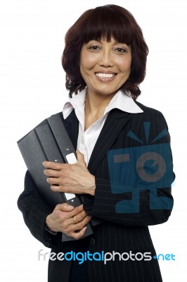 Smiling Female Holding Binder Stock Photo