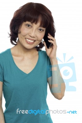 Smiling Female Talking Over Phone Stock Photo