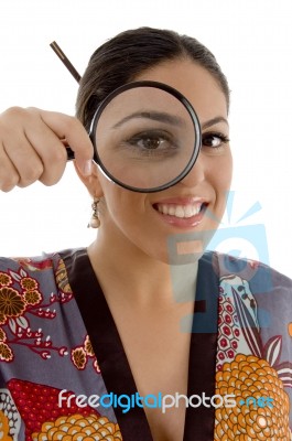 Smiling Female Watching Through Magnifying Lens Stock Photo