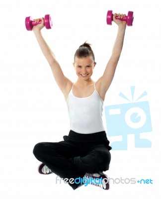 Smiling Fit Girl Working Out With Dumbbells Stock Photo
