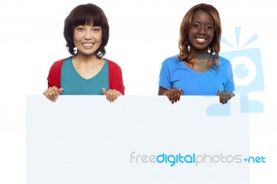 Smiling Friends Holding White Board Stock Photo