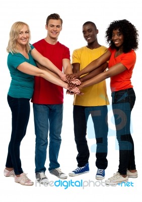 Smiling Friends Joining Hands Stock Photo