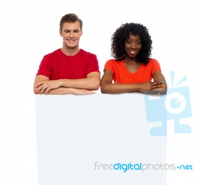 Smiling Friends With Blank Board Stock Photo