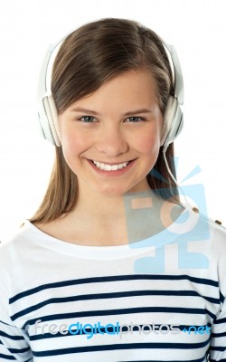 Smiling Girl Enjoying Music Stock Photo