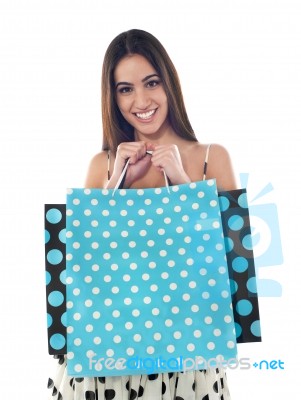 Smiling Girl Holding Shopping Bags Stock Photo