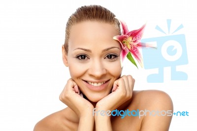 Smiling Girl With Pink Flower Stock Photo