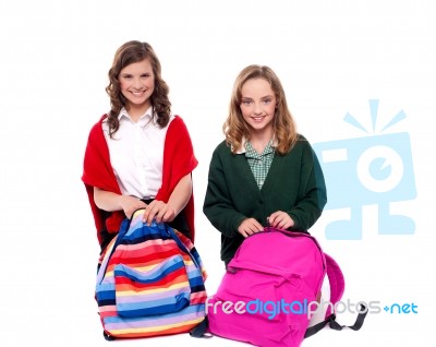 Smiling Girls Unzipping School Bag Stock Photo