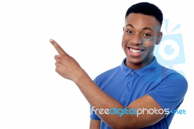 Smiling Guy Pointing Away Stock Photo