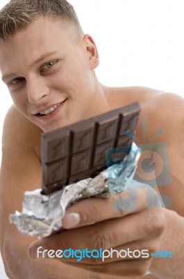 Smiling Guy Showing Chocolate Stock Photo