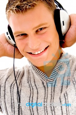 Smiling Handsome Male Listening To Music Stock Photo