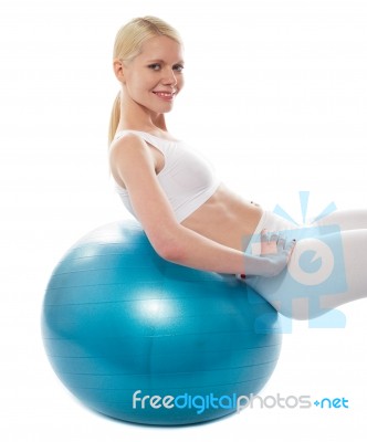 Smiling Lady Leaning On Gym Ball Stock Photo