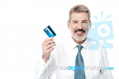 Smiling Male Executive Showing Debit Card Stock Photo