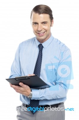 Smiling Male Secretary Holding A Clipboard Stock Photo