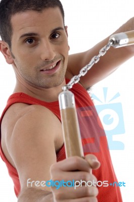 Smiling Male Showing Nunchaku Stock Photo