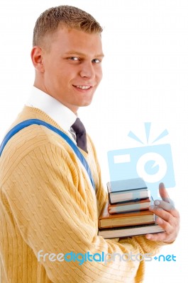 Smiling Male Student Holding Books Stock Photo
