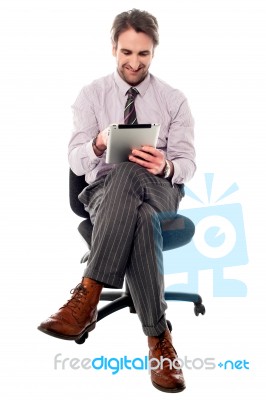 Smiling Manager Working On Tablet Device Stock Photo