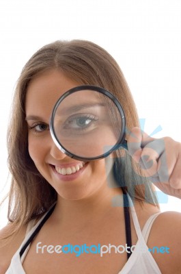 Smiling Model Holding Magnifying Glass Stock Photo