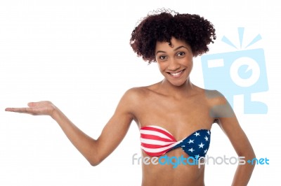 Smiling Model In Stars And Stripes Bikini Presenting Copy Space Stock Photo