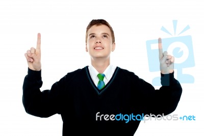 Smiling School Boy Pointing Up Stock Photo