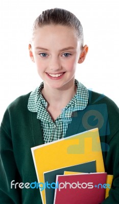 Smiling School Girl Holding Books Stock Photo