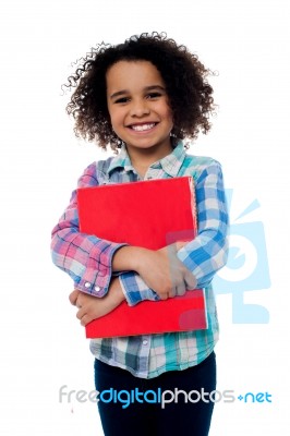 Smiling Schoolgirl Holding A Book Stock Photo