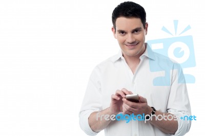 Smiling Smart Using His Cell Phone Stock Photo