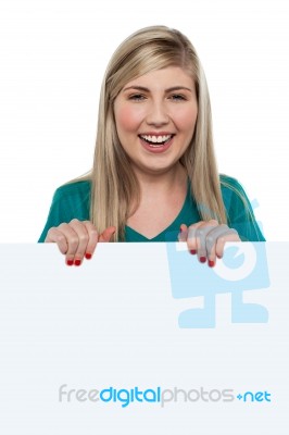 Smiling Teen Girl Standing Behind Blank Whiteboard Stock Photo