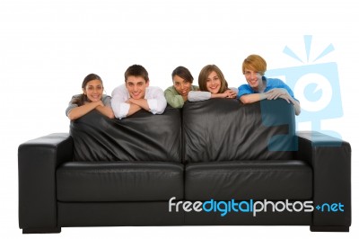 Smiling Teenage Friends With Sofa Stock Photo