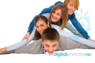 Smiling Teenagers Laying On Floor Stock Photo