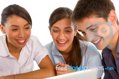 Smiling Teenagers Using Laptop Stock Photo