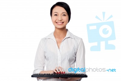 Smiling Woman Posing With Keyboard Stock Photo