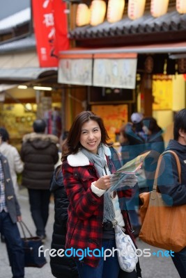 Smiling Woman Tourist Hold Map Stock Photo