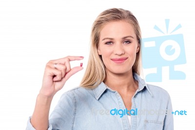 Smiling Woman With A Pill In Hand Stock Photo