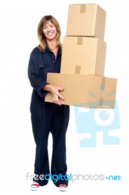 Smiling Woman With Stack Of Cardboard Boxes Stock Photo